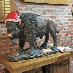 Bronze statue of Buffalo wearing a Christmas hat