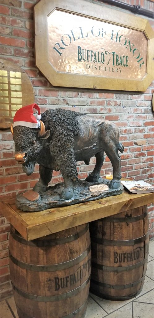 Bronze statue of Buffalo wearing a Christmas hat