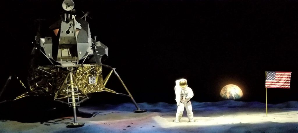 Lunar Theater exhibiting the Apollo 11 landing on the moon with the landing module, astronaut, U.S flag and earth in the background