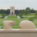 Lorraine American Cemetery stone eagle looking over the grave markers