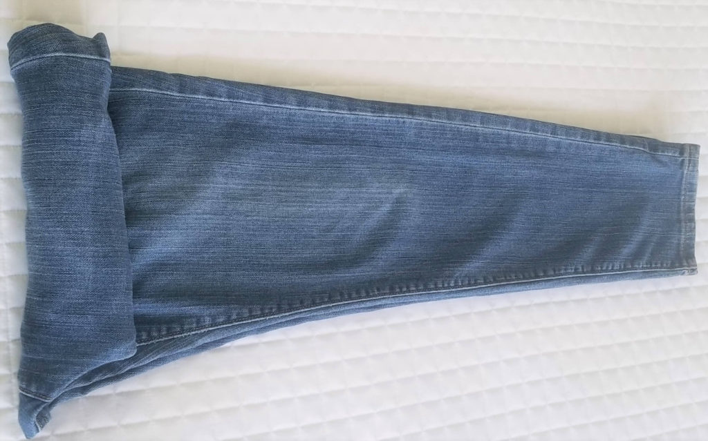 jeans being rolled for packing