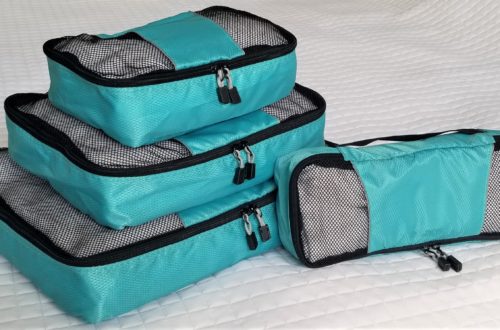 stack of 4 teal packing cubes with black trim