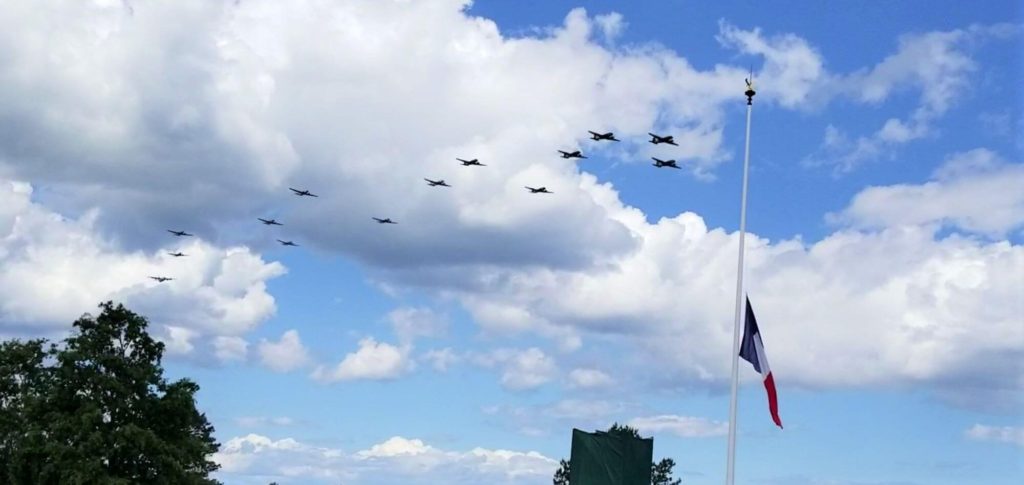 dakota planes fly over normandy cemetery with the french flag