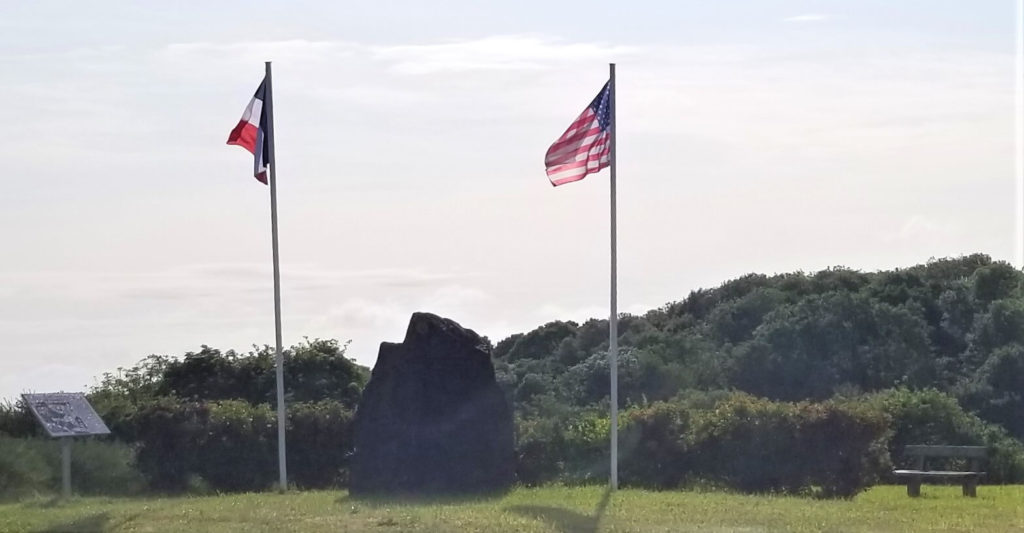 american and french flags fly side by side