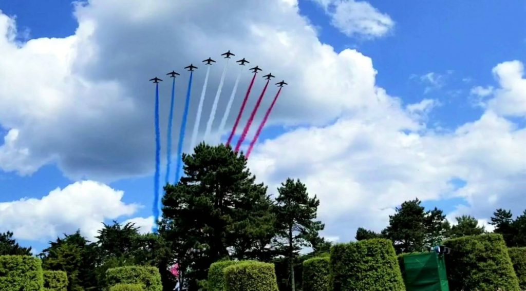jets fly over leaving red white and blue smoke streams