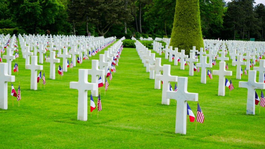 rows of white crosses with american and french flags